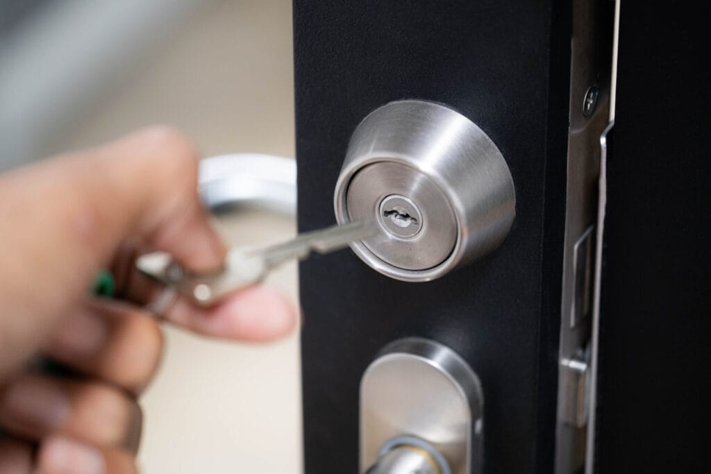 Hand Inserting Key into Door Lock